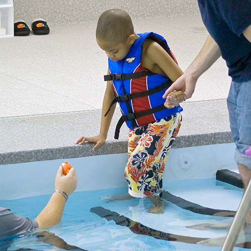 Monarch student with autism doing therapeutic adaptive swimming 